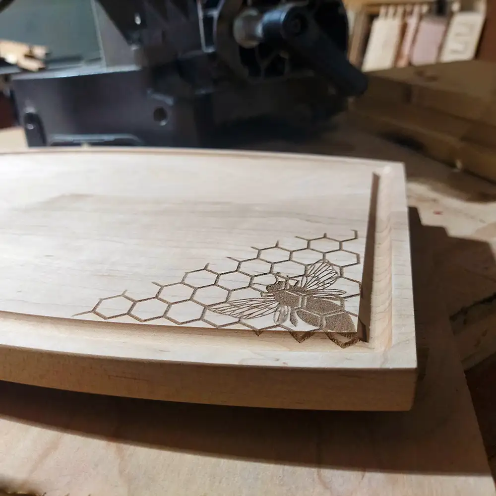 Maple cutting board with honeycomb bee design