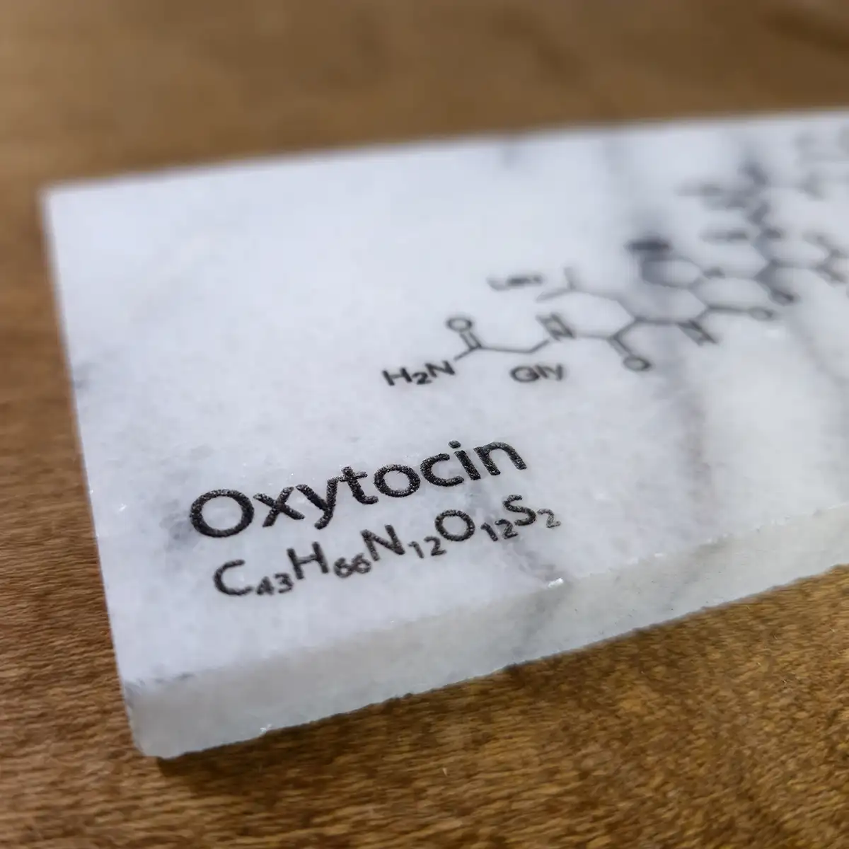 Oxytocin engraved on marble tile