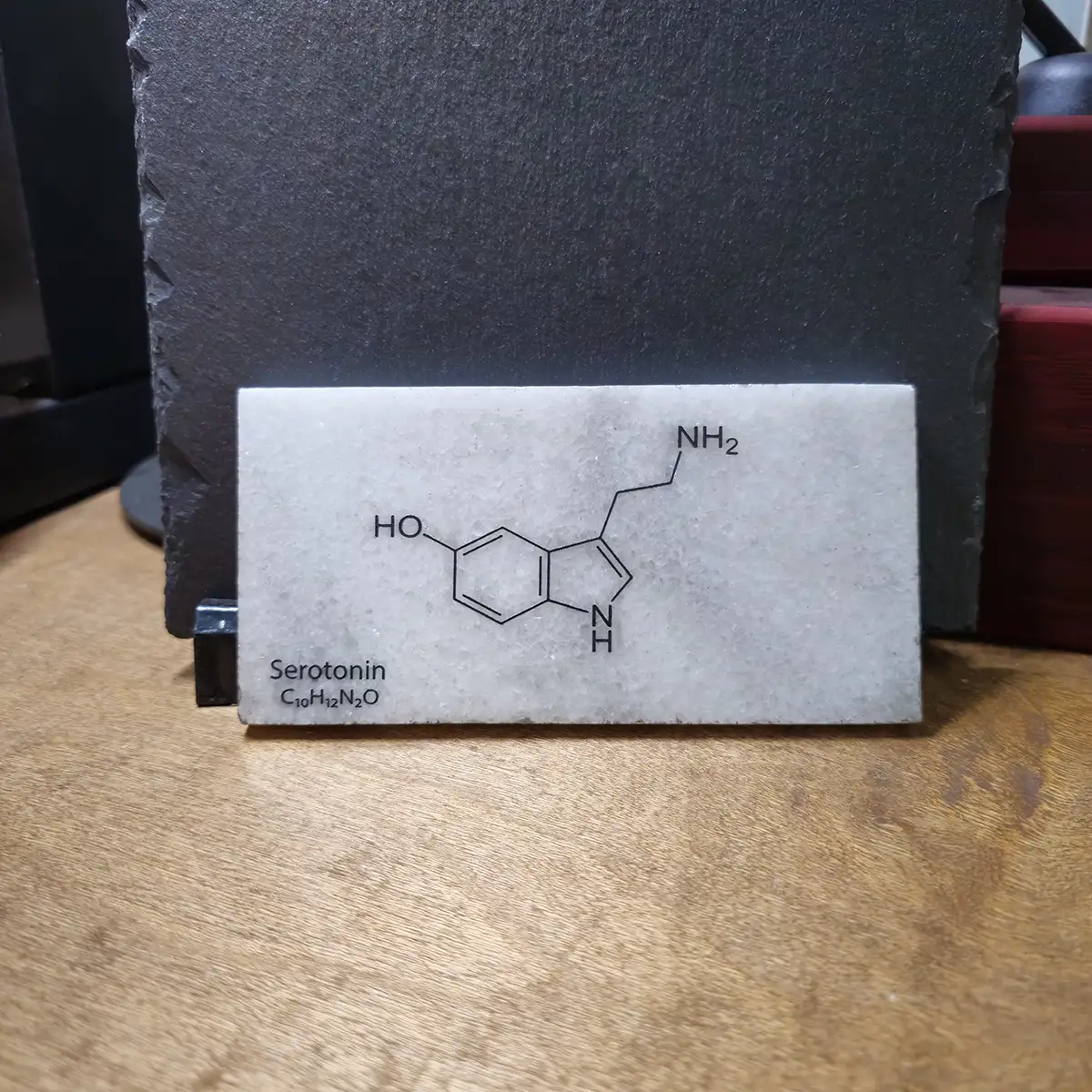 Serotonin engraved marble tile